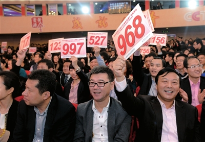 昨天，在央視2013年黃金資源廣告招標競購大會現場，企業代表舉牌競標。圖/CFP